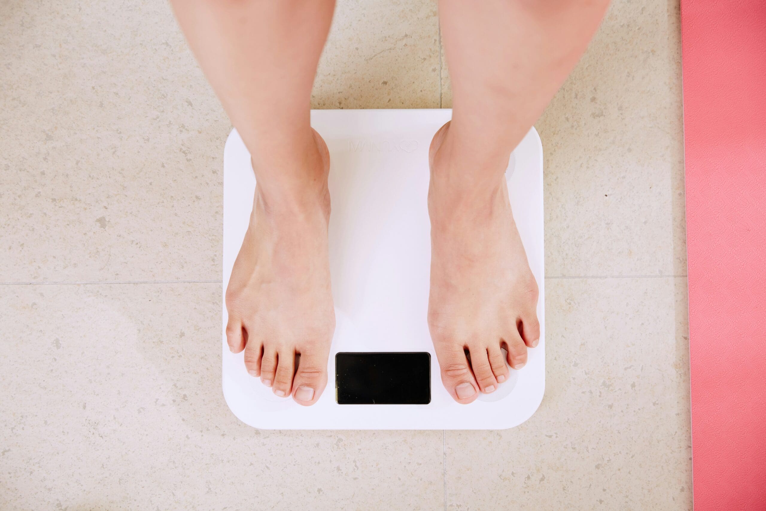 Weight loss mindset concept with person standing on scale focusing on long-term health progress