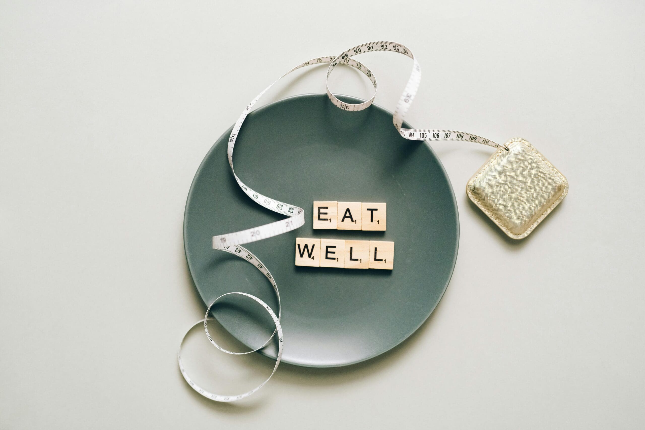 Dietary Guidelines for Americans concept with plate, measuring tape, and eat well message